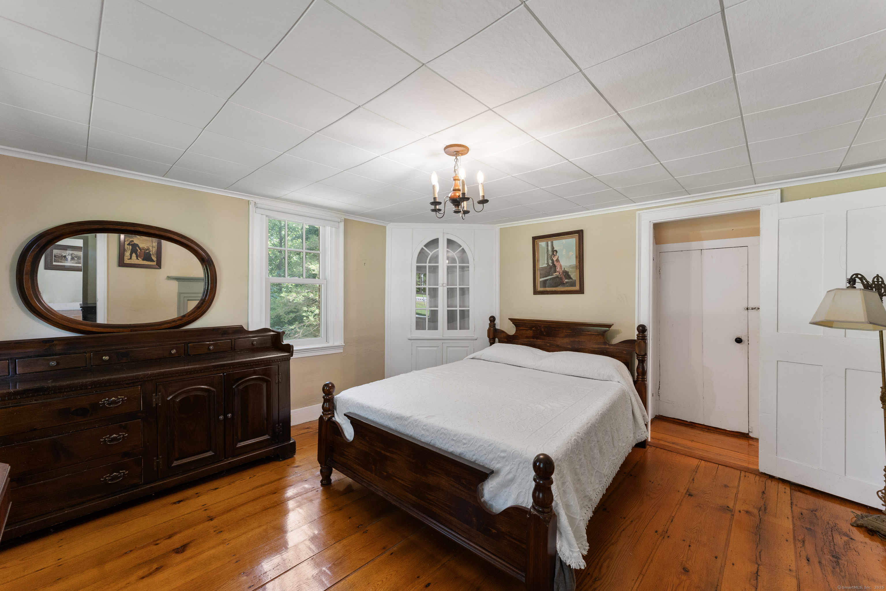 393 North Canterbury Road Canterbury, CT 06331 - Photo 19 of 40 a bed room with a bed and a chandelier