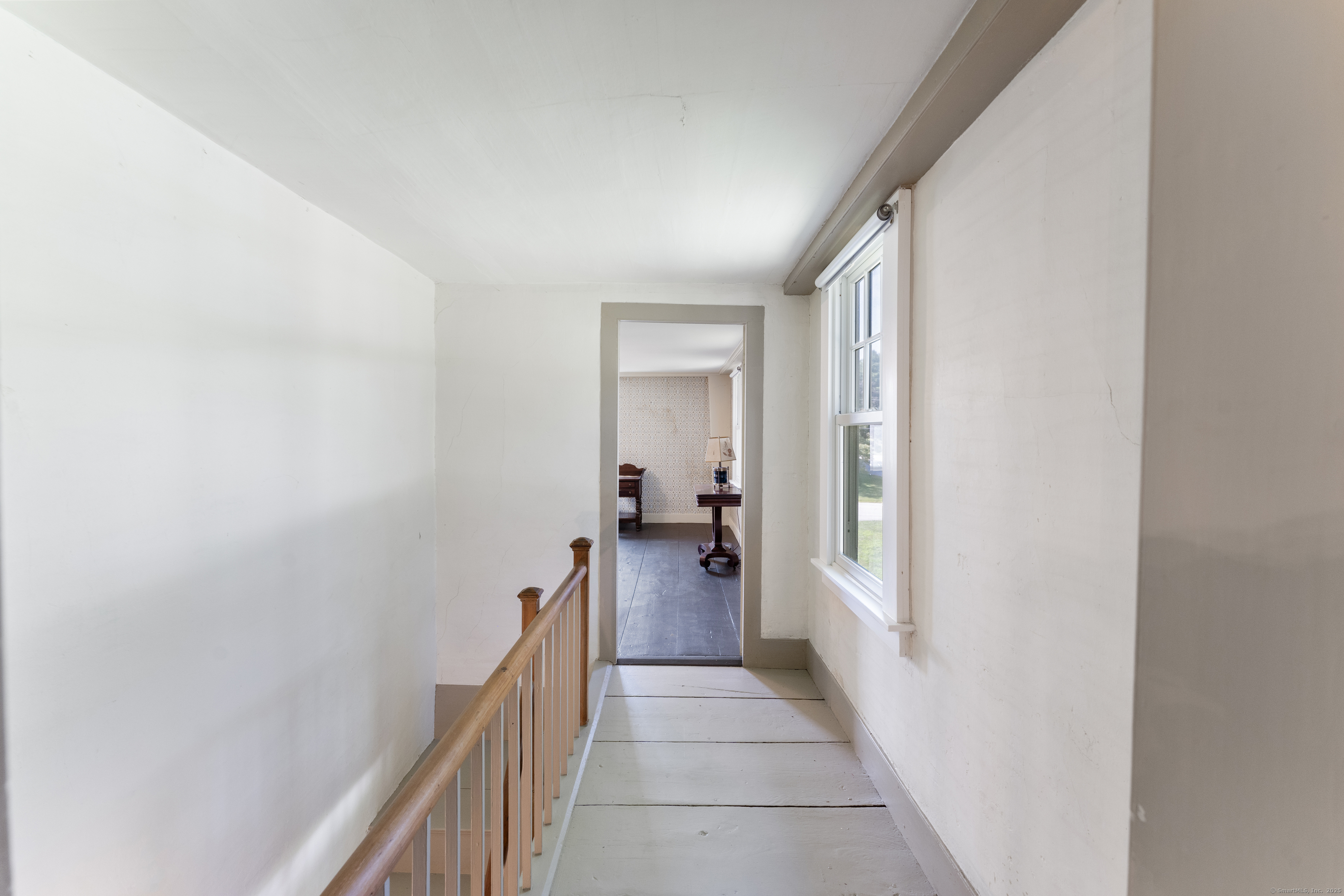 393 North Canterbury Road Canterbury, CT 06331 - Photo 30 of 40 a hallway with a wooden floor and a bathroom