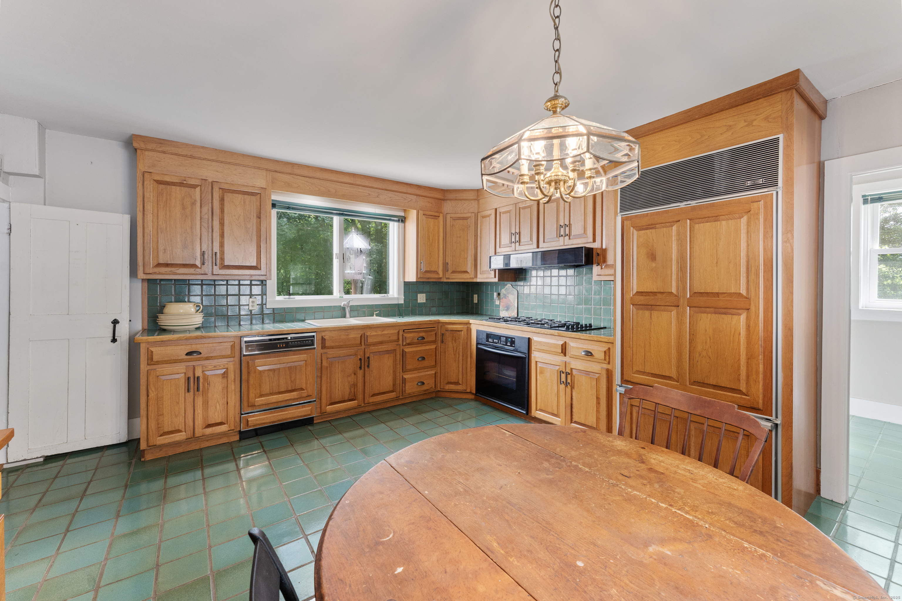 393 North Canterbury Road Canterbury, CT 06331 - Photo 7 of 40 a kitchen with granite countertop a sink cabinets stainless steel appliances and a window
