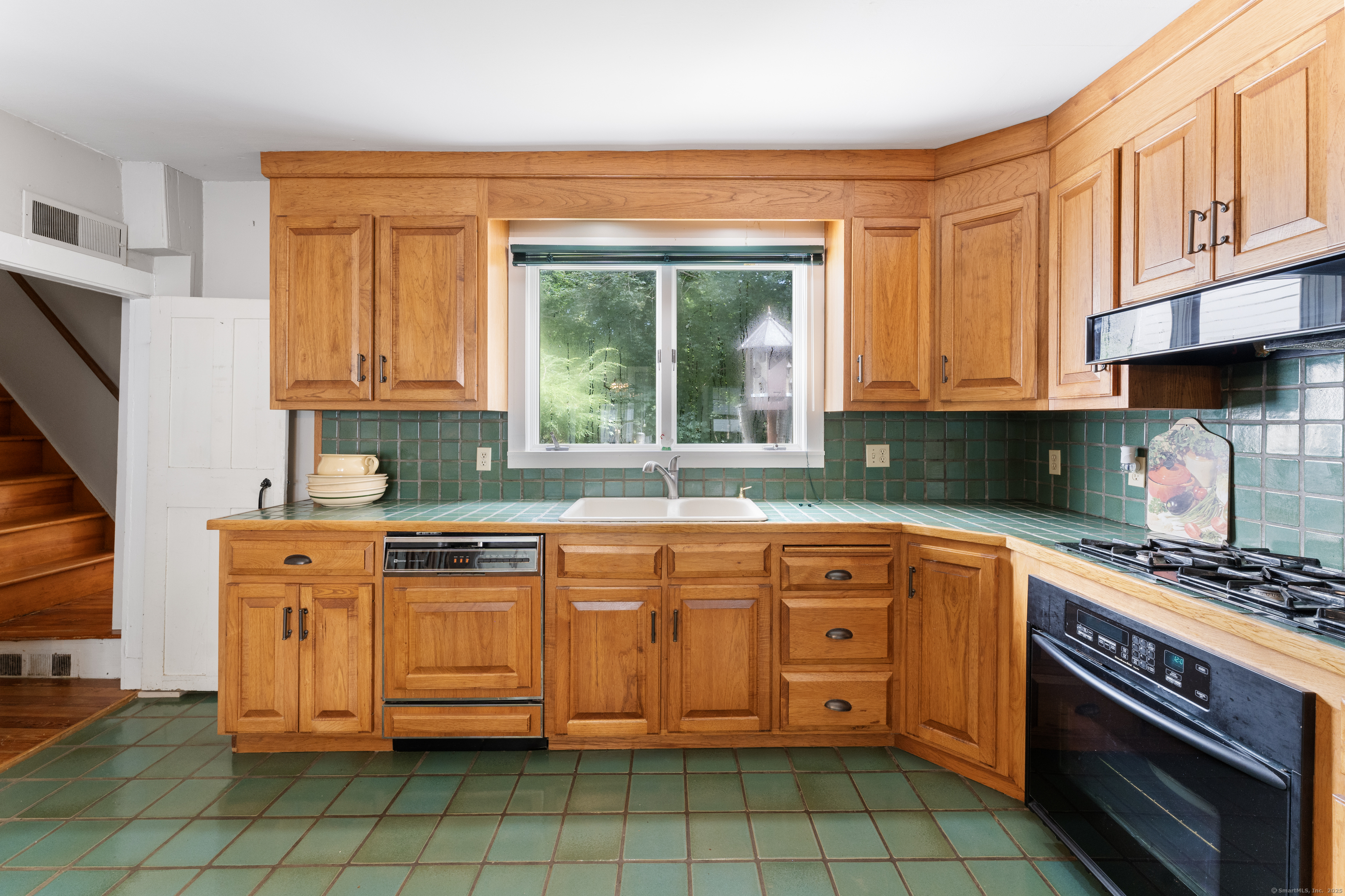 393 North Canterbury Road Canterbury, CT 06331 - Photo 8 of 40 a kitchen with stainless steel appliances granite countertop a stove a sink and a microwave