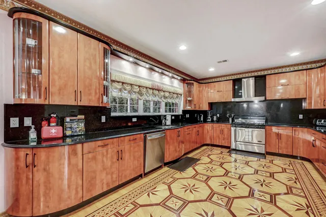 a view of a hallway with windows and chandelier