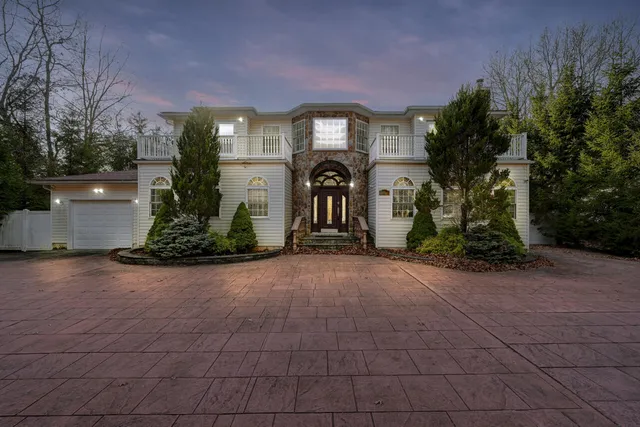 front view of a brick house with a yard