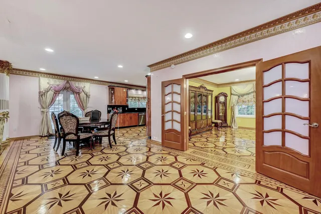 a view of a house with a small yard and wooden fence and floor to ceiling window