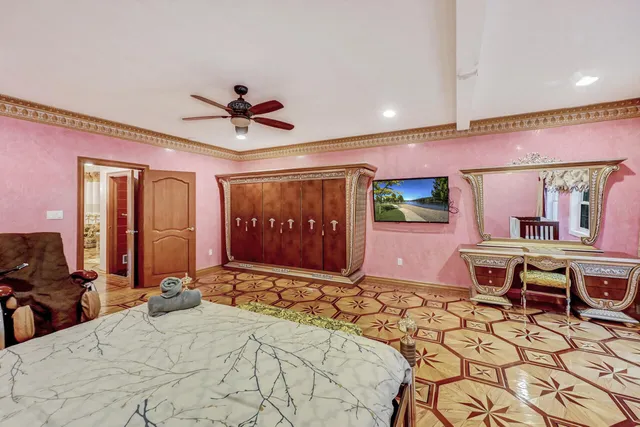 a spacious bedroom with a bed mirror and window