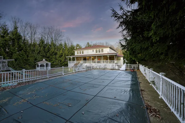a front view of a house with a yard and a garage