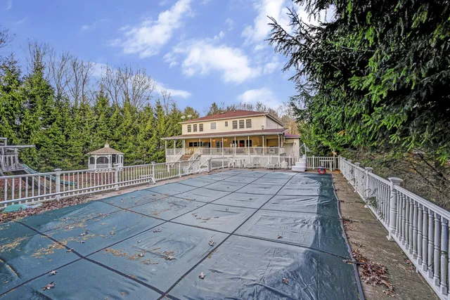 a view of a house with large windows and a small yard