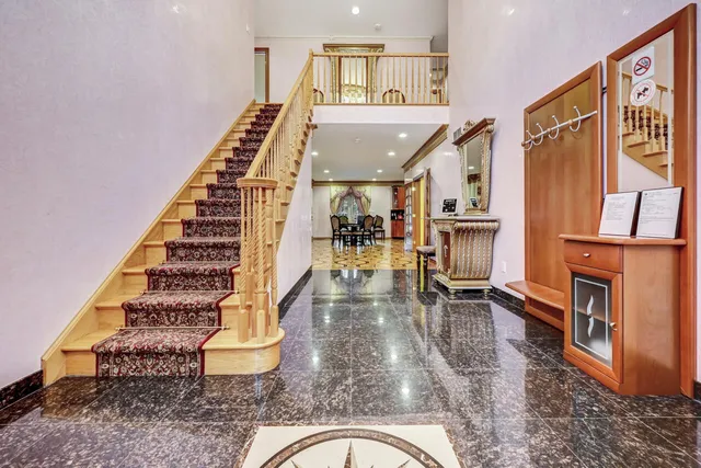 a living room with lots of furniture and a view of kitchen
