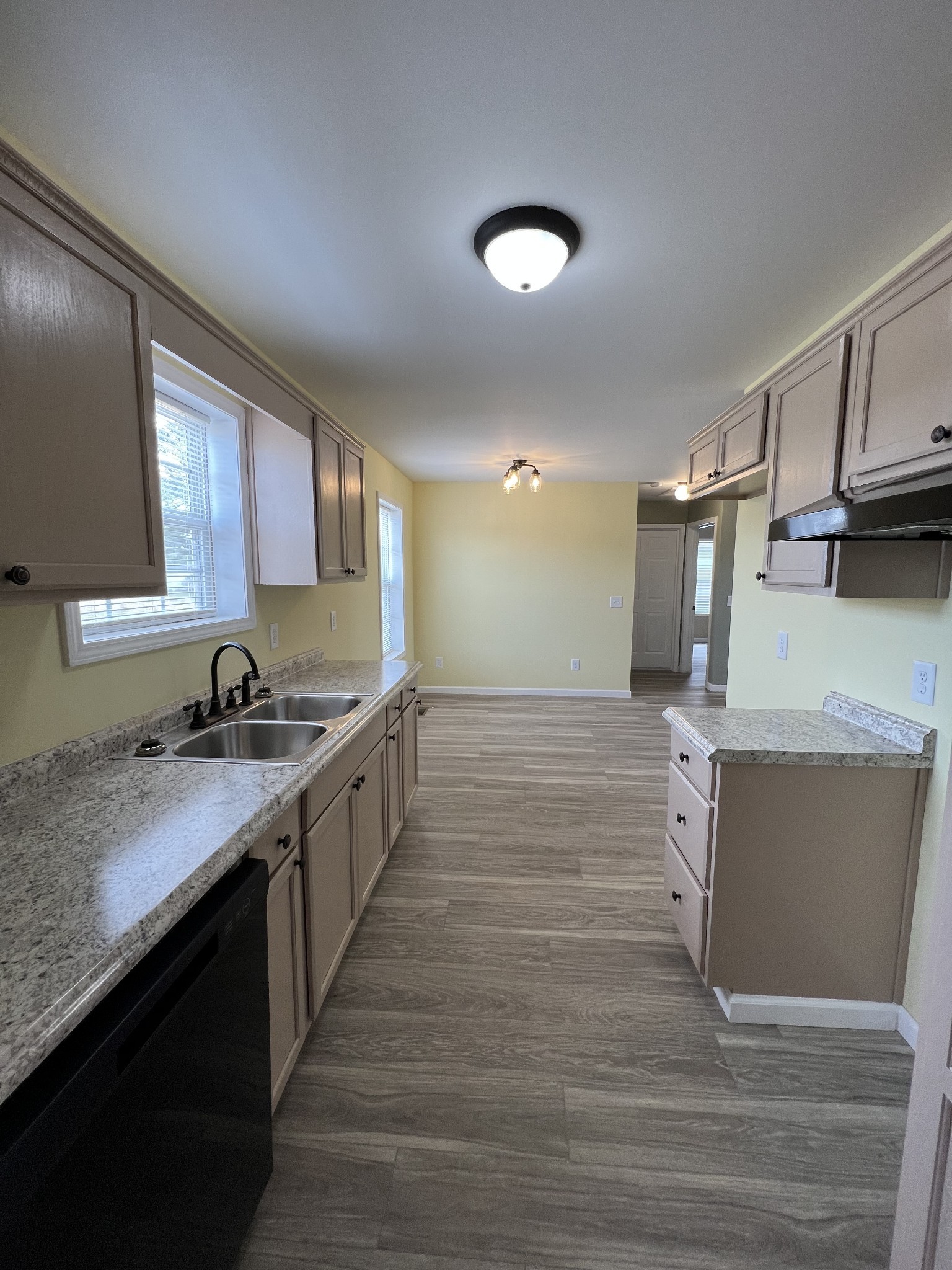 2363 Willette Road Red Boiling Springs, TN 37150 - Photo 4 of 10 a large kitchen with stainless steel appliances granite countertop a sink and dishwasher a stove with wooden floor