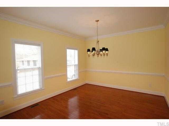 1209 North Blount Street Raleigh, NC 27604 - Photo 3 of 12 Sunny Formal Dining with Crown Molding, Chair rail, & Hardwood Flooring.