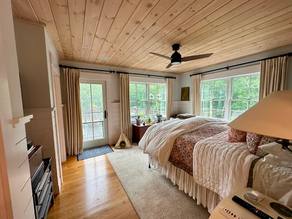 a bedroom with a large bed and a large window