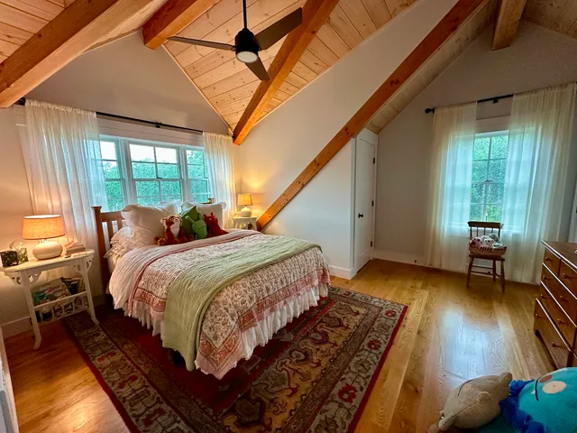 a bed room with a bed and a chair