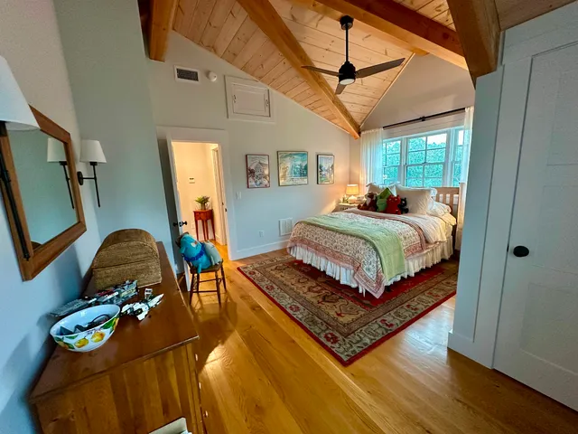 a bedroom with a bed mirror and window