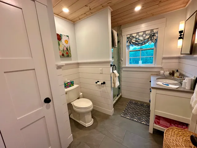a bathroom with a sink toilet and shower