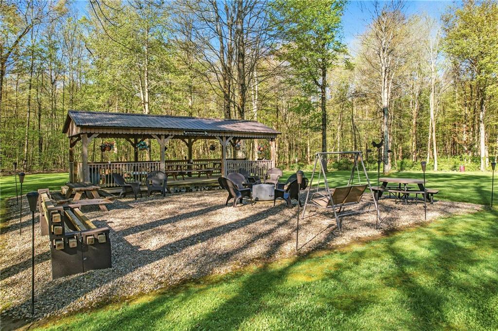 9935 Greiser Road Conneaut Lake, PA 16316 - Photo 12 of 50 a view of backyard with deck and outdoor seating
