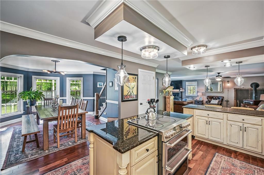 9935 Greiser Road Conneaut Lake, PA 16316 - Photo 20 of 50 a kitchen with stainless steel appliances granite countertop a stove and a view of living room