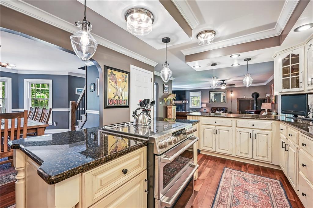 9935 Greiser Road Conneaut Lake, PA 16316 - Photo 21 of 50 a open kitchen with stainless steel appliances granite countertop a stove cabinets and window