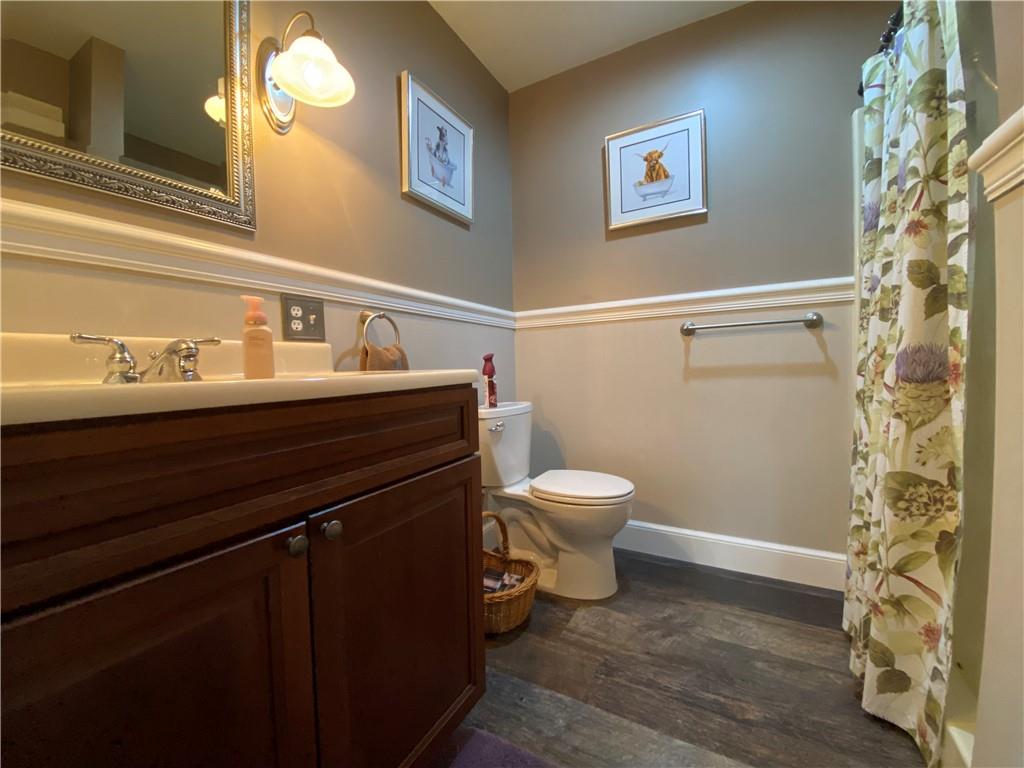 9935 Greiser Road Conneaut Lake, PA 16316 - Photo 42 of 50 a bathroom with a sink a toilet and a mirror