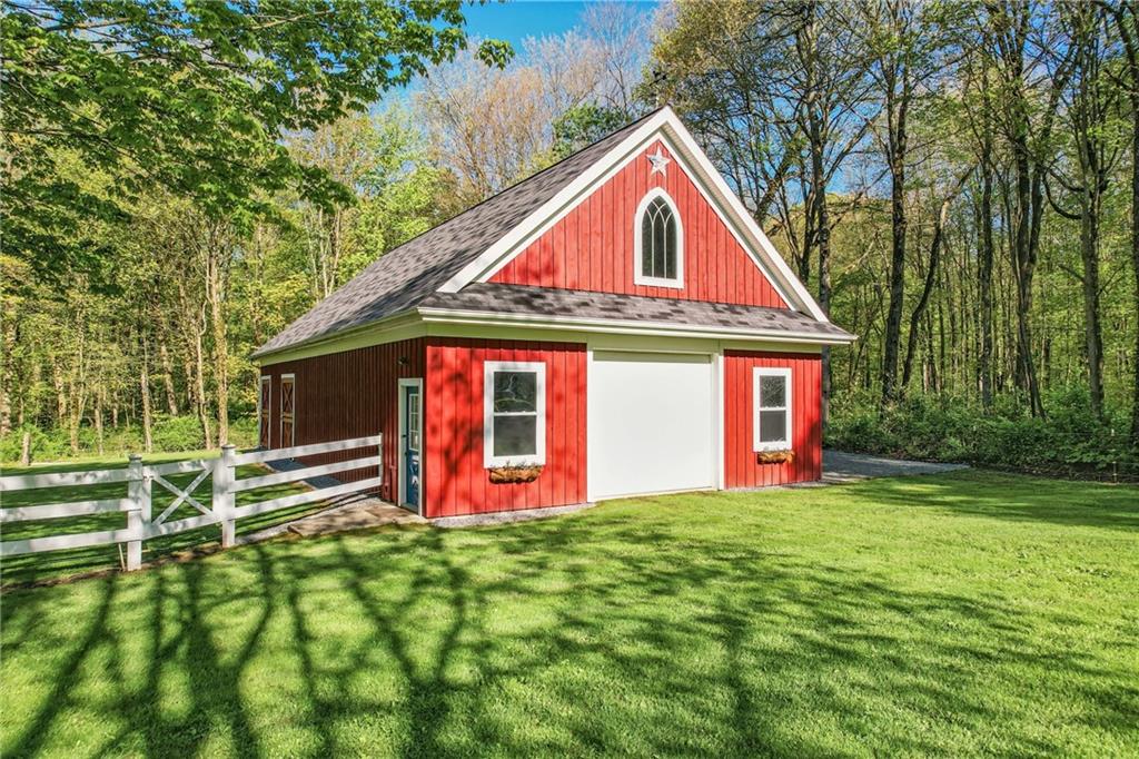 9935 Greiser Road Conneaut Lake, PA 16316 - Photo 9 of 50 a front view of a house with a yard and garage