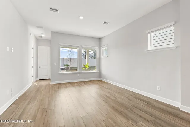 a view of staircase with lots of frames on wall and wooden floor