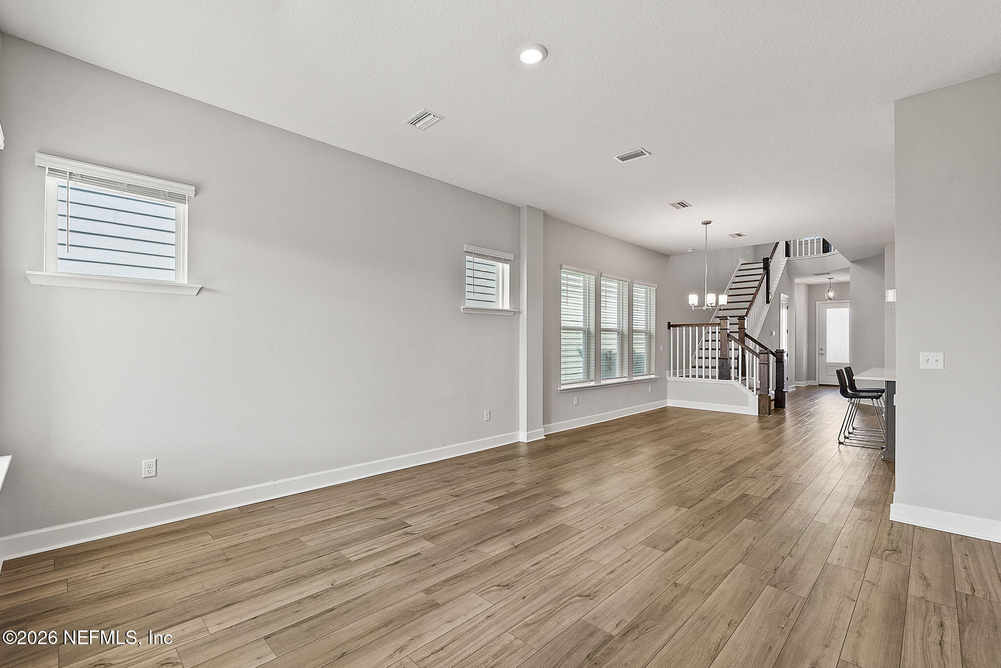 11465 Catalyst Road Jacksonville, FL 32256 - Photo 15 of 61 a view of empty room with wooden floor and a window