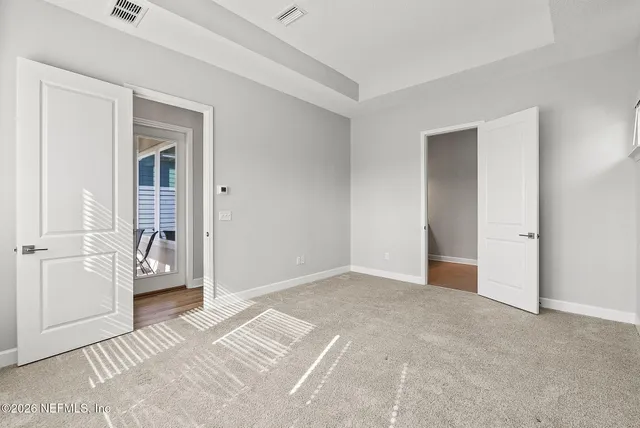 a view of a patio with table and chairs under an umbrella