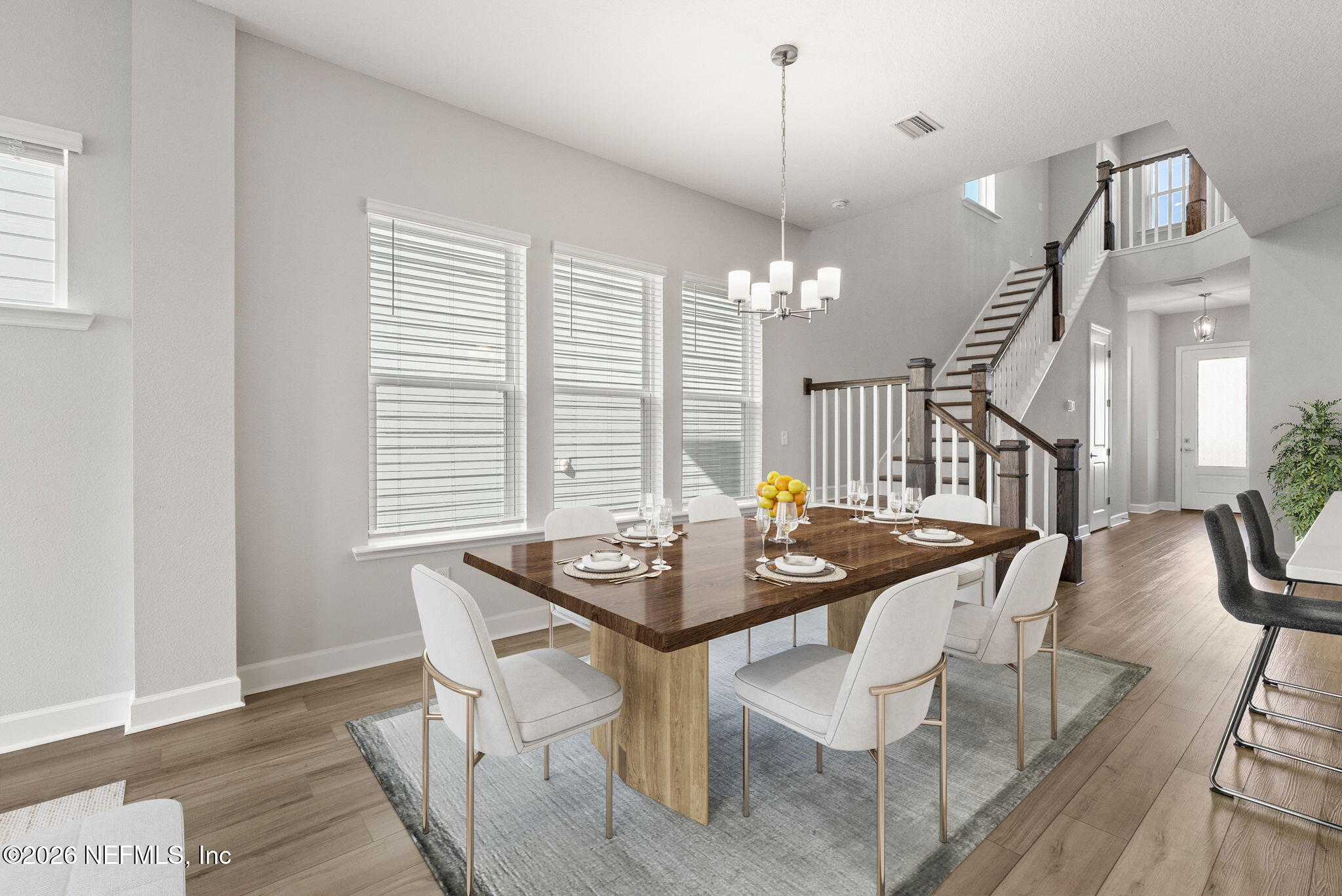 11465 Catalyst Road Jacksonville, FL 32256 - Photo 3 of 61 a dining room with wooden floor a chandelier a wooden table and chairs