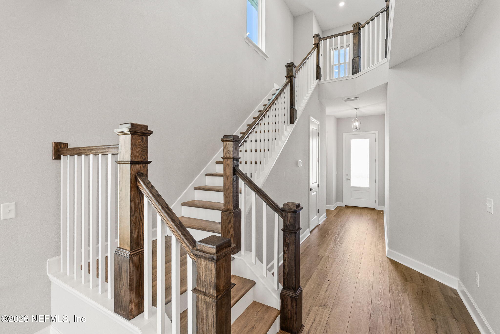 11465 Catalyst Road Jacksonville, FL 32256 - Photo 32 of 61 a view of staircase with lots of frames on wall and wooden floor