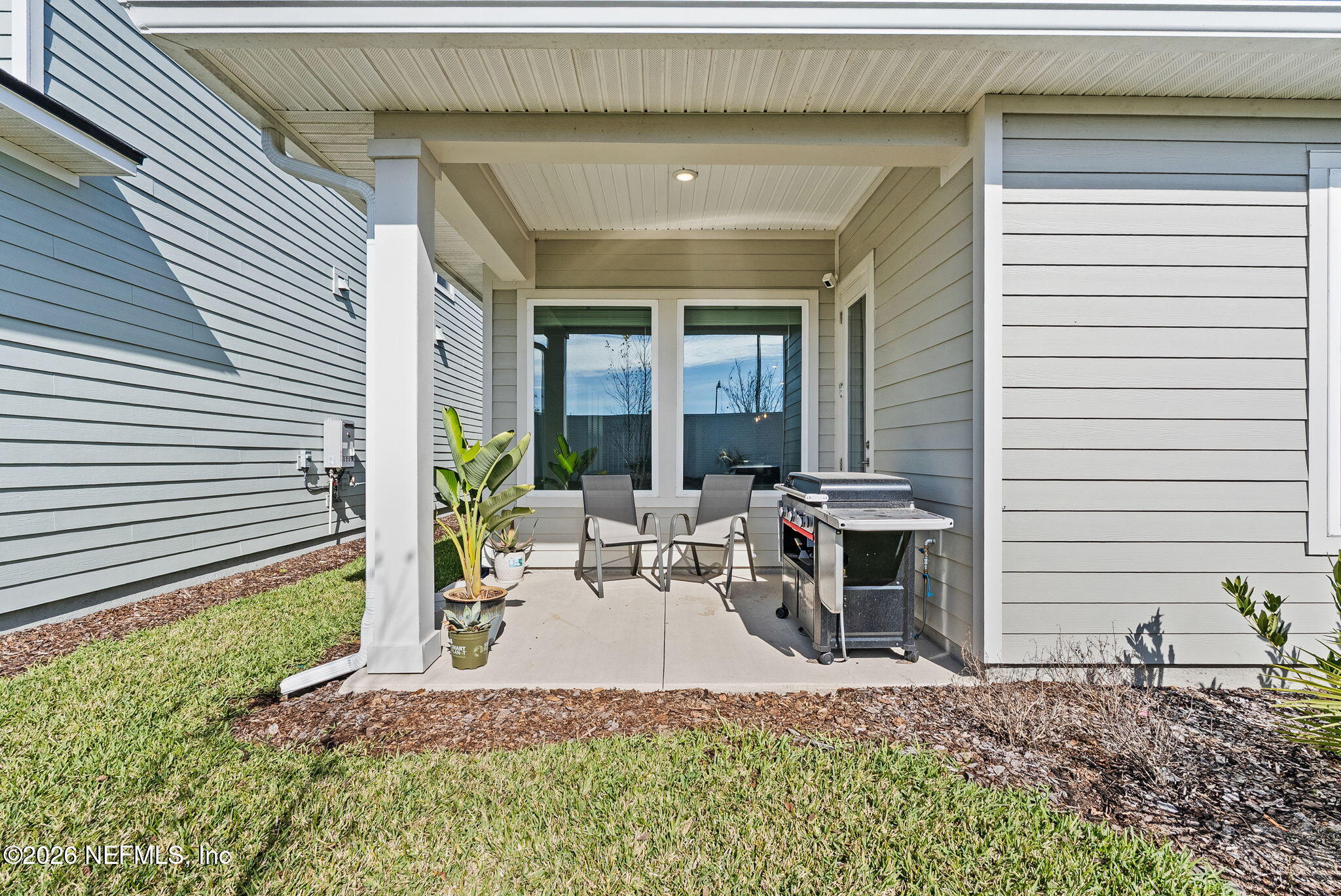 11465 Catalyst Road Jacksonville, FL 32256 - Photo 41 of 61 a view of a patio with table and chairs and potted plants
