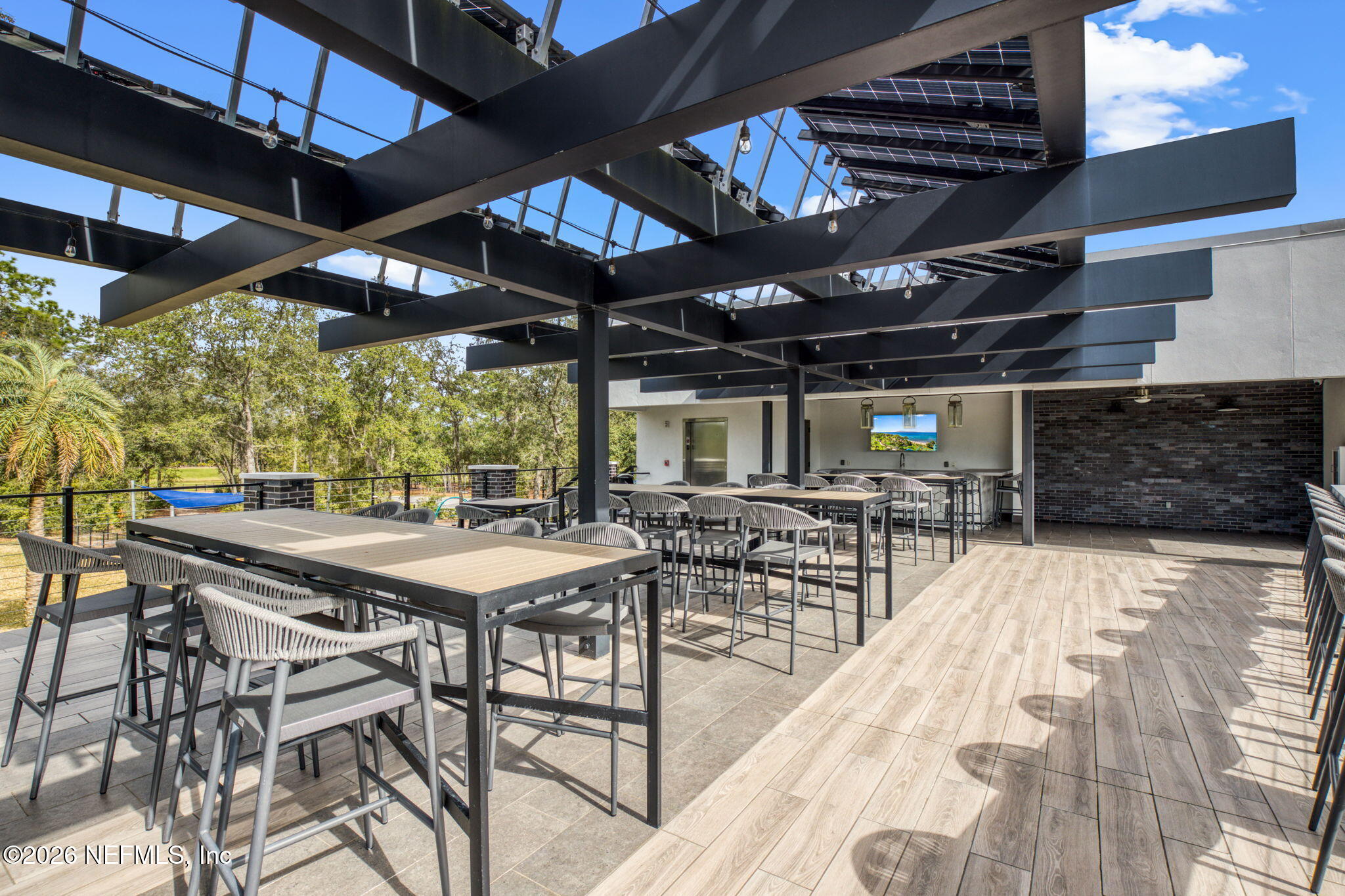 11465 Catalyst Road Jacksonville, FL 32256 - Photo 54 of 61 a view of a patio with table and chairs under an umbrella