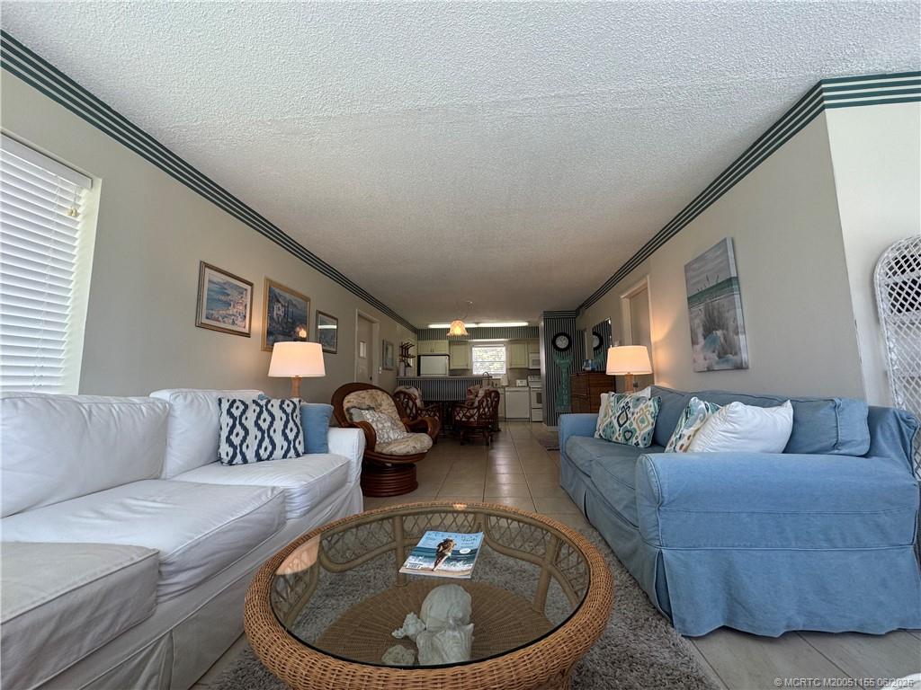 1501 Northeast Ocean Boulevard, Unit 9 Stuart, FL 34996 - Photo 15 of 41 a living room with furniture and a couch