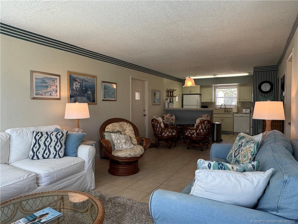 1501 Northeast Ocean Boulevard, Unit 9 Stuart, FL 34996 - Photo 17 of 41 a living room with furniture and a couch