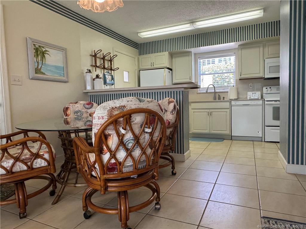 1501 Northeast Ocean Boulevard, Unit 9 Stuart, FL 34996 - Photo 20 of 41 a kitchen with a cabinets and a stove