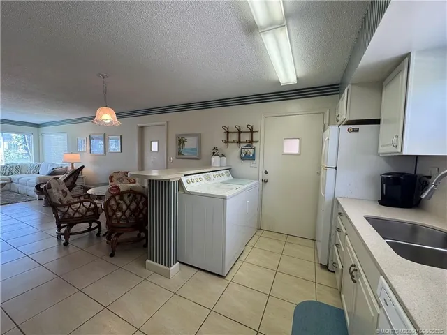 a kitchen with a sink appliances and cabinets