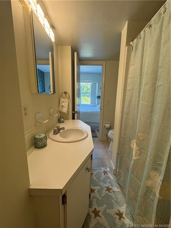 1501 Northeast Ocean Boulevard, Unit 9 Stuart, FL 34996 - Photo 29 of 41 a bathroom with sink a mirror a bathtub and shower