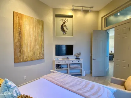 a bedroom with a bed and a television