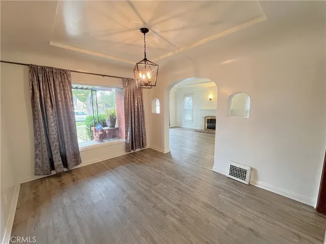 a view of a livingroom with wooden floor and a ceiling fan