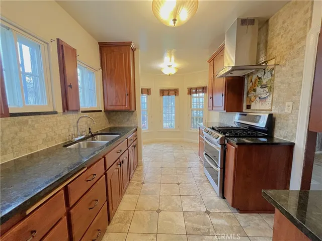 a kitchen with stainless steel appliances granite countertop a stove and a sink