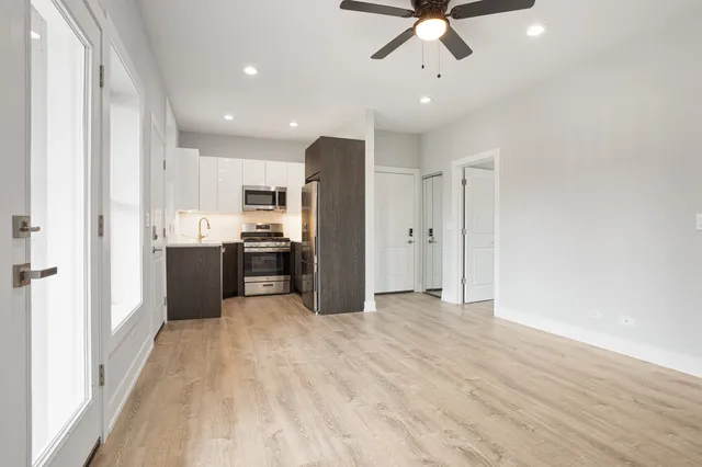 a view of a kitchen with a sink and stainless steel appliances