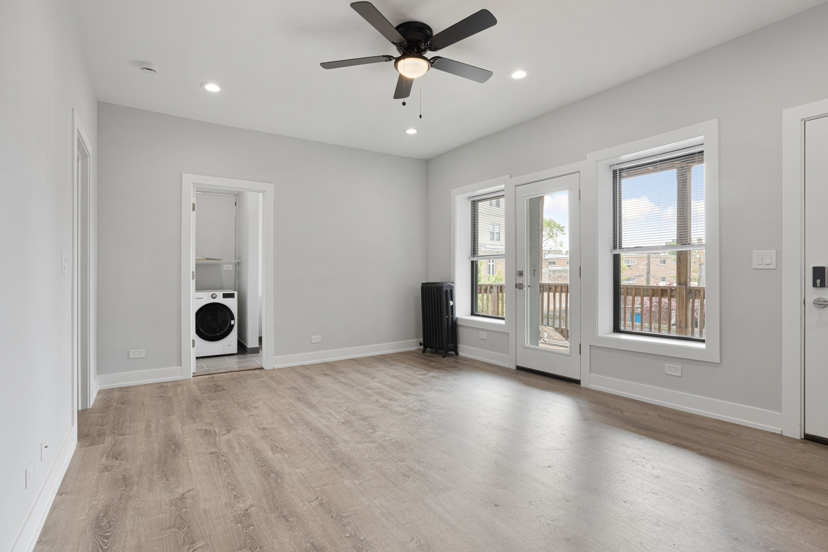 1243 West Morse Avenue, Unit 2 Chicago, IL 60626 - Photo 5 of 13 a view of an empty room with a window and a kitchen