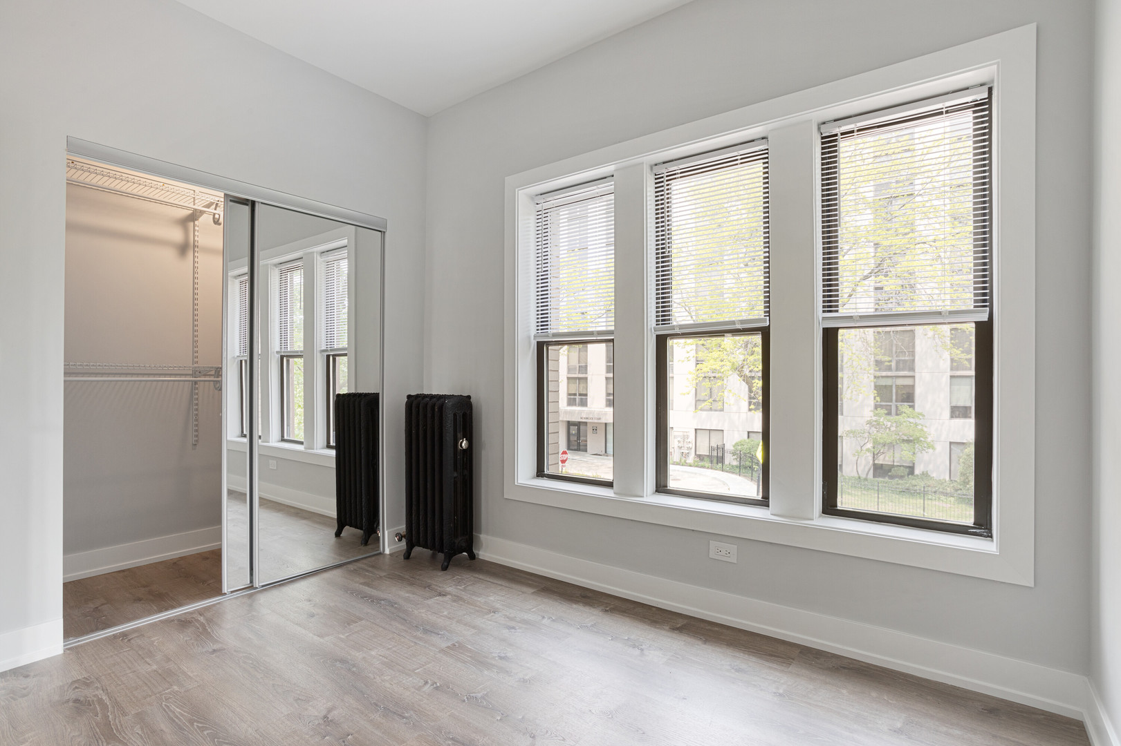 1243 West Morse Avenue, Unit 2 Chicago, IL 60626 - Photo 8 of 13 an empty room with windows and closet