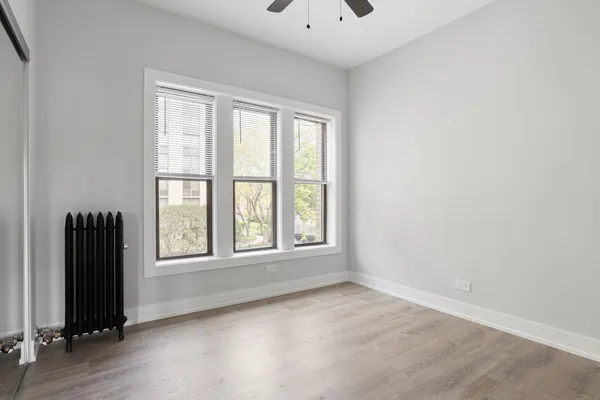 an empty room with windows and closet