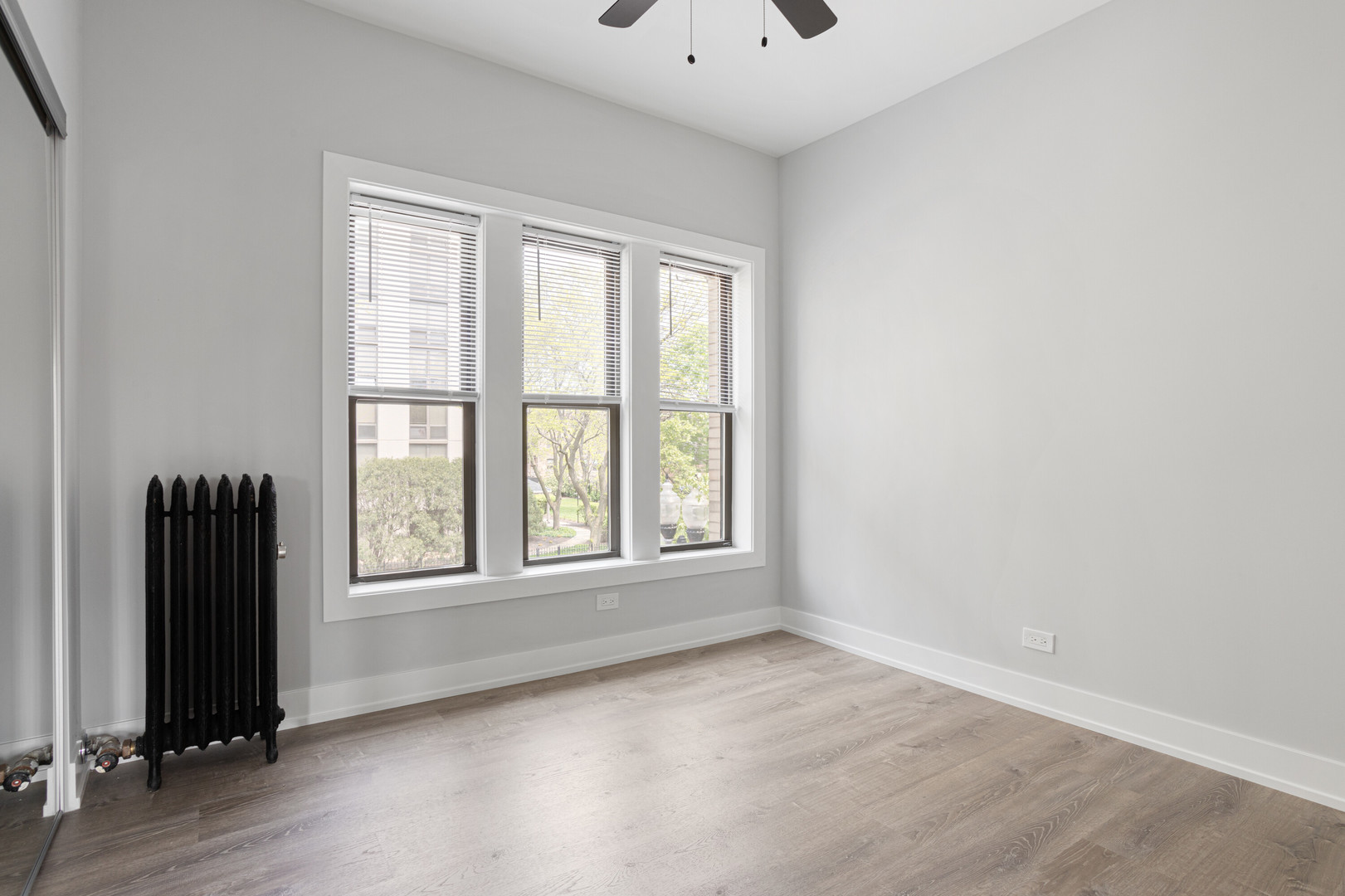1243 West Morse Avenue, Unit 2 Chicago, IL 60626 - Photo 9 of 13 an empty room with windows and closet