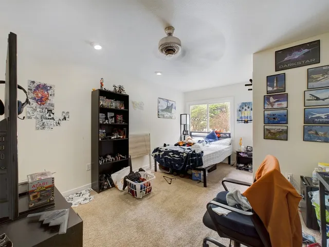 a living room with furniture toys and a flat screen tv