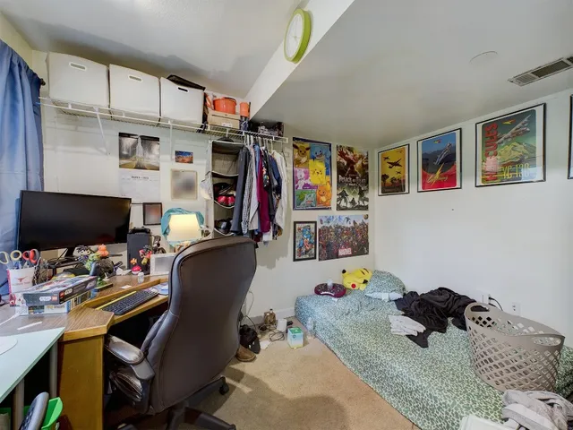 a bedroom with a workspace