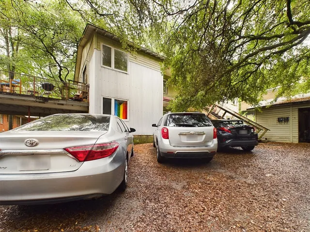 a white car parked in front of a house