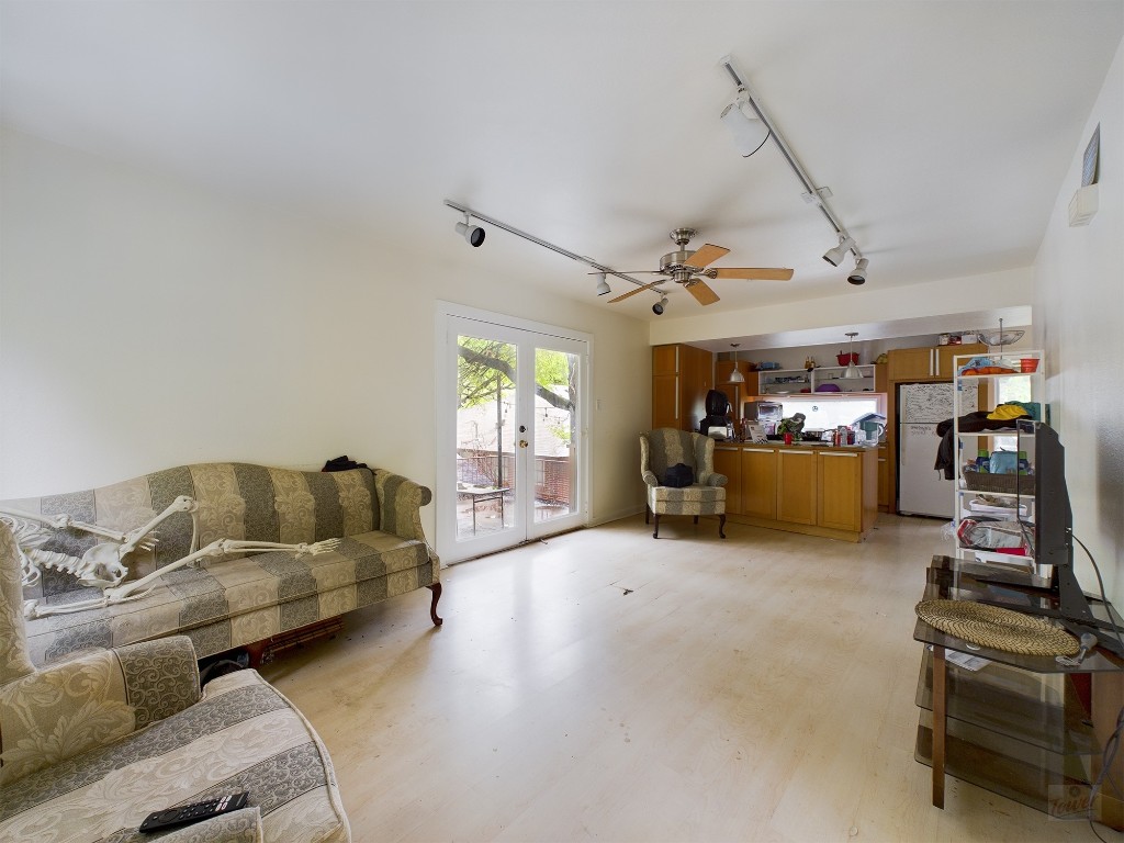 915 Keith Lane, Unit 104 Austin, TX 78705 - Photo 2 of 14 a living room with furniture and a flat screen tv