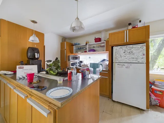 a kitchen with a refrigerator and a sink
