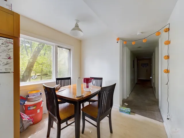 a view of a dining room with furniture and a window