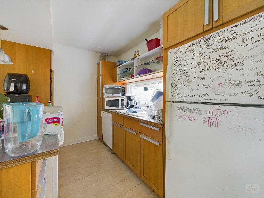 915 Keith Lane, Unit 104 Austin, TX 78705 - Photo 5 of 14 a view of a kitchen with fridge and wooden floor