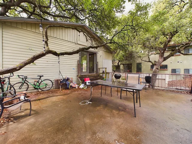 a backyard of a house with table and chairs